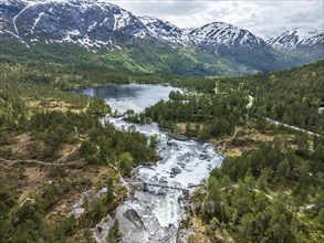 Bridge over waterfall Likholefossen, Gaularfjell mountain range, river Gaula, early spring, aerial