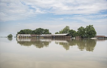 Morigaon, India. 4 July 2024. A school partially submerged in flood in Morigaon district in India's