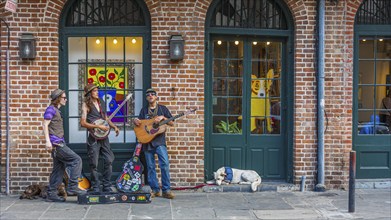 Street performers playing music on sidewalk in the French Quarter of New Orleans, Louisiana, USA,