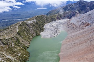 Lake with sandbank, dead trees, crater rim of Chaiten volcano, aerial view, Park Pumalin,