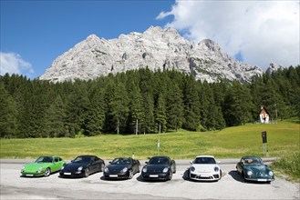 On the right Porsche 956 from the 50s from the left five Porsche sports car series 911 from