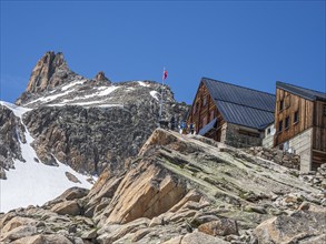 Tourists outside mountain Cabin 'Cabane d'Orny, swiss alps, canton Valais, Switzerland, Europe