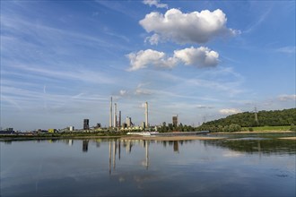 Industrial backdrop of the ThyssenKrupp Steel steelworks in Bruckhausen, on the Rhine, cargo ship,