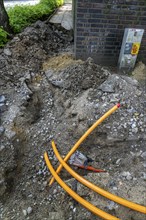 Laying of fibre optic cables, empty conduits are laid under a pavement, in which the actual fibre