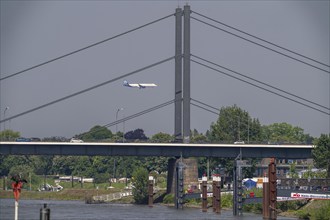 The Rhine near Düsseldorf, Theodor-Heuss-Bridge, aeroplane approaching Düsseldorf Airport, North