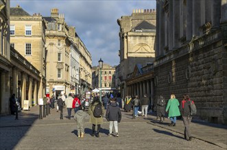 Shoppers walking in pedestrianised street in city centre, Union Street and Stall Street, Bath,