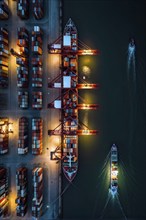 Aerial view of a cargo harbor with its geometric patterns of cranes and parked ships at night, AI