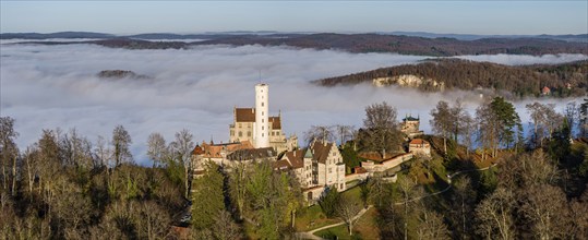 Sunshine in the mountains, fog in the Echaz valley. Lichtenstein Castle in the Swabian Alb. The