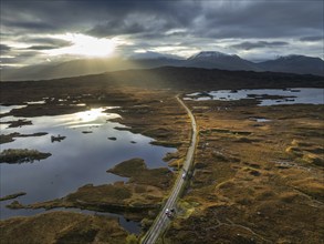 Morning light, cloudy mood, sunbeams, loch, moor, mountain landscape, aerial view, road, autumn,