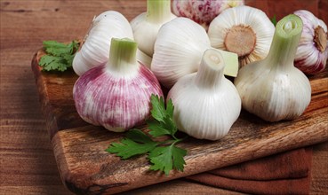 Fresh young garlic, white and purple color, on a wooden table, no people