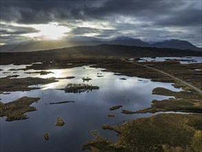 Morning light, cloudy mood, sunbeams, loch, moor, mountain landscape, aerial view, road, autumn,