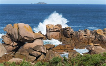 Rock formations in the sea with foaming waves under a blue sky, Ploumanac'h, Ploumanach,