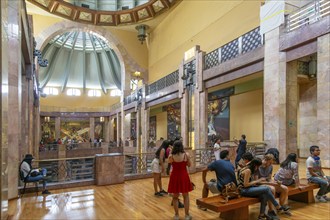 People viewing artwork murals inside Palacio de Bellas Artes, Palace of Fine Arts, Mexico City,