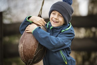 6-year-old smiling boy with a boxing pear