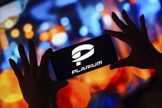 In this photo illustration, the Plarium Global logo is displayed on a smartphone screen