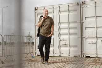 Caucasian Man posing in front of industrial background in Albufeira, Algarve, Portugal, Europe