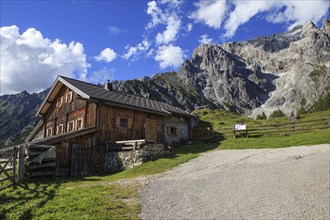 Typical mountain huts in the Austrian Alps, on a sunny day with rocky mountains in the background