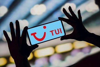 In this photo illustration, the TUI Airways Limited logo is displayed on a smartphone screen