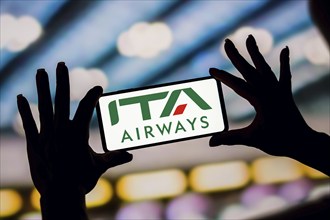 In this photo illustration, the ITA Airways logo is displayed on a smartphone screen