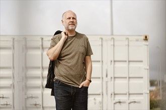 Caucasian Man posing in front of industrial background in Albufeira, Algarve, Portugal, Europe