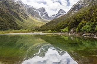 Tranquil mountain lake Mackenzie at the famous Routeburn Track, Fiordland National Park, South