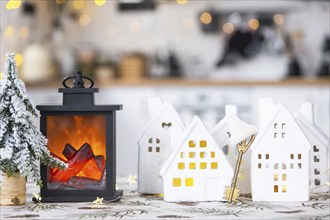 Key and tiny house of a small size on cozy home with Christmas decor on table of festive white