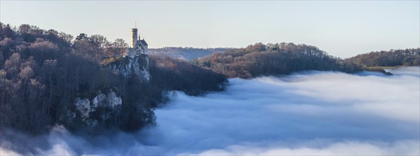 Sunshine in the mountains, fog in the Echaz valley. Lichtenstein Castle in the Swabian Alb. The