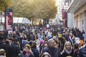 Crowds of people out and about in the Königstraße shopping street. The shops in the pedestrian zone