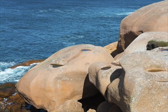 Close-up of jagged rocks with a view of the blue water, Ploumanac'h, Ploumanach, Perros-Guirec,