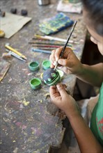 Sri Lankan woman painting a wooden ball, Oak Ray Woodcarvings, Naula, Matale, Central Province, Sri