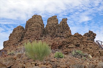 Brown rocks rise into a cloudy desert landscape, Roques de los Muchachos, La Palma, Canary Islands,