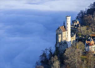 Sunshine in the mountains, fog in the Echaz valley. Lichtenstein Castle in the Swabian Alb. The