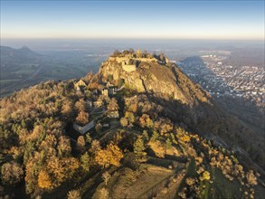 Aerial view of the volcanic cone Hohentwiel with the castle ruins illuminated by the evening sun,