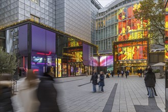 Porsche Brand Store and Breuninger department stores' in the evening. Shops with logos in the