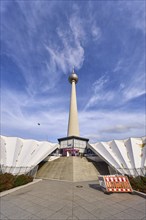 Berlin television tower with stairs against blue sky with cirrostratus clouds, Panoramastraße,