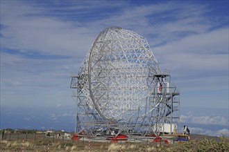 A large telescope with a metal structure under a blue sky, no light pollution, Observatory, Roques