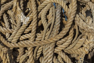 Close-up of old coiled mixed size ropes on the ground, Port of Gruz, Dubrovnik, Croatia, Europe