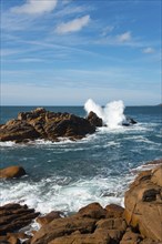 Coastal landscape with rocks and breaking waves on a sunny day, Ploumanac'h, Ploumanach,