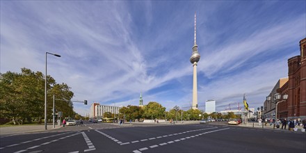 Berlin television tower under blue sky with cirrostratus clouds, intersection of Bahnhofstraße and