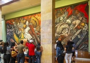 People viewing 'Katharsis' 1934 mural by Jose Clemente Orozco, Palacio de Bellas Artes, Palace of