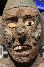 Stone carved face of Centzonhuitzuahuah, deity of pulque, archaeological site and museum of Templo