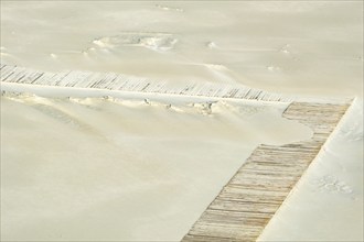 Path made of wooden planks on the sandy beach