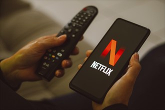 In this photo illustration, the Netflix logo seen displayed on a smartphone