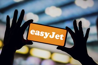 In this photo illustration, the EasyJet Airlines logo is displayed on a smartphone screen