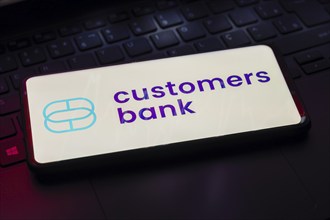 In this photo illustration, the Customers Bank logo seen displayed on a smartphone