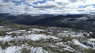 Scenic mountain vista with snow patches on fields and a cloudy sky. Posof, Ardahan, TURKEY