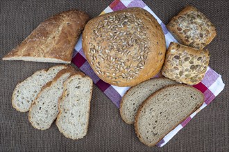 Fresh bread on table, top view. Baked dark bread and sliced bread