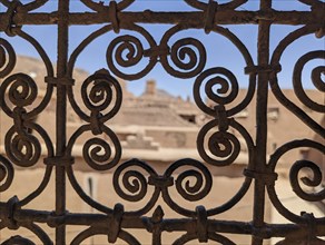 Ornate traditional window grid of a berber house ruin in the city center of Amezrou, Morocco,