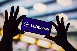 In this photo illustration, the Deutsche Lufthansa AG logo is displayed on a smartphone screen