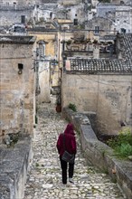 A person walking through the rain on a path in downton Matera, Southern Italy